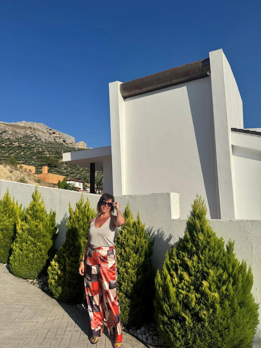 Pantalón ancho con estampado en tonos cálidos, a juego con el cárdigan y la blazer alba